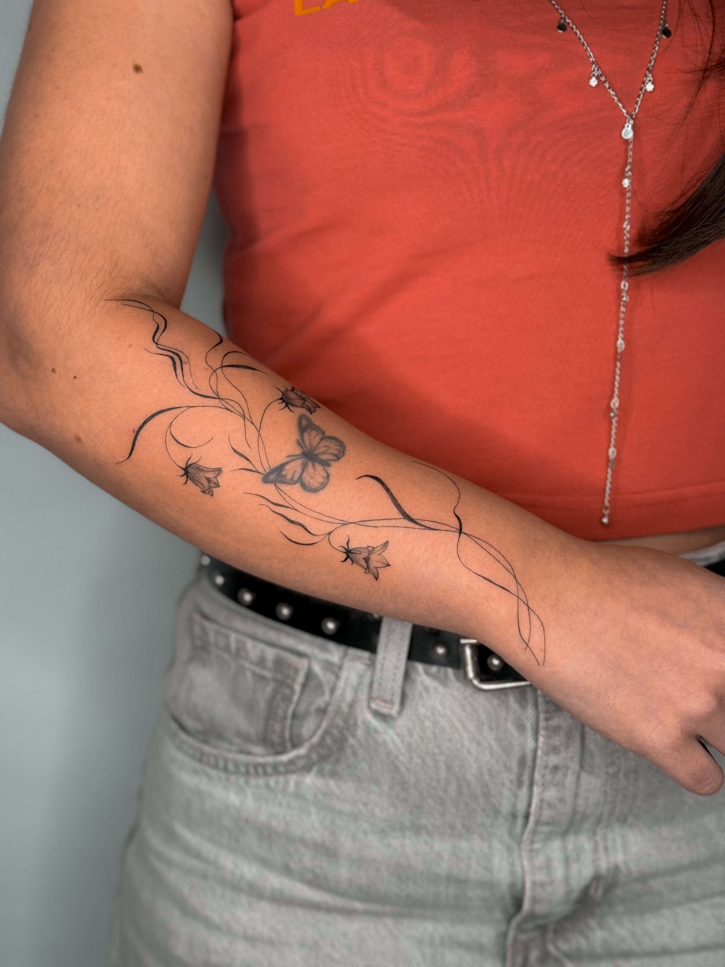 Fine line bluebell tattoo on the arm