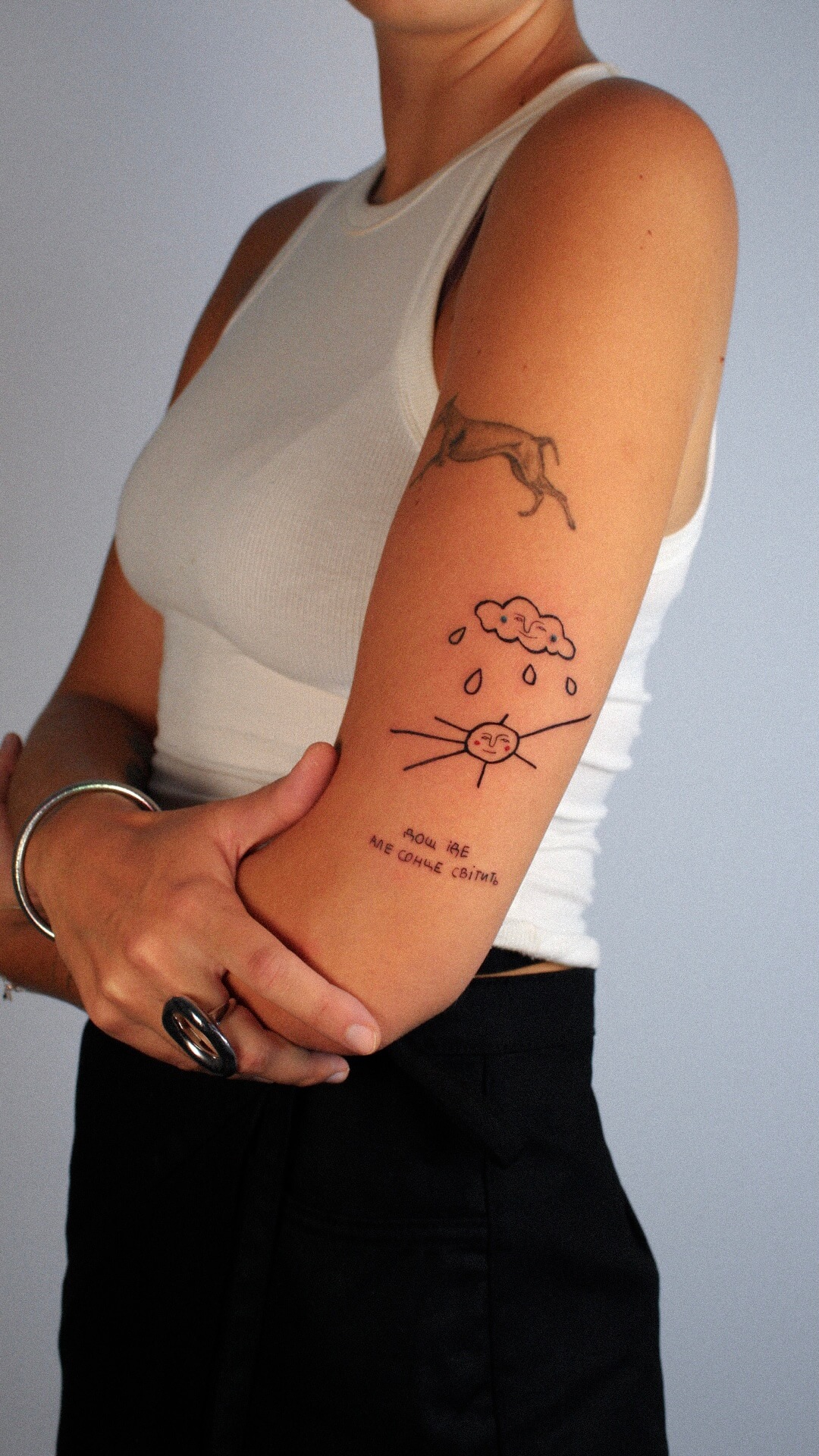 Fine line botanical tattoo on the upper arm