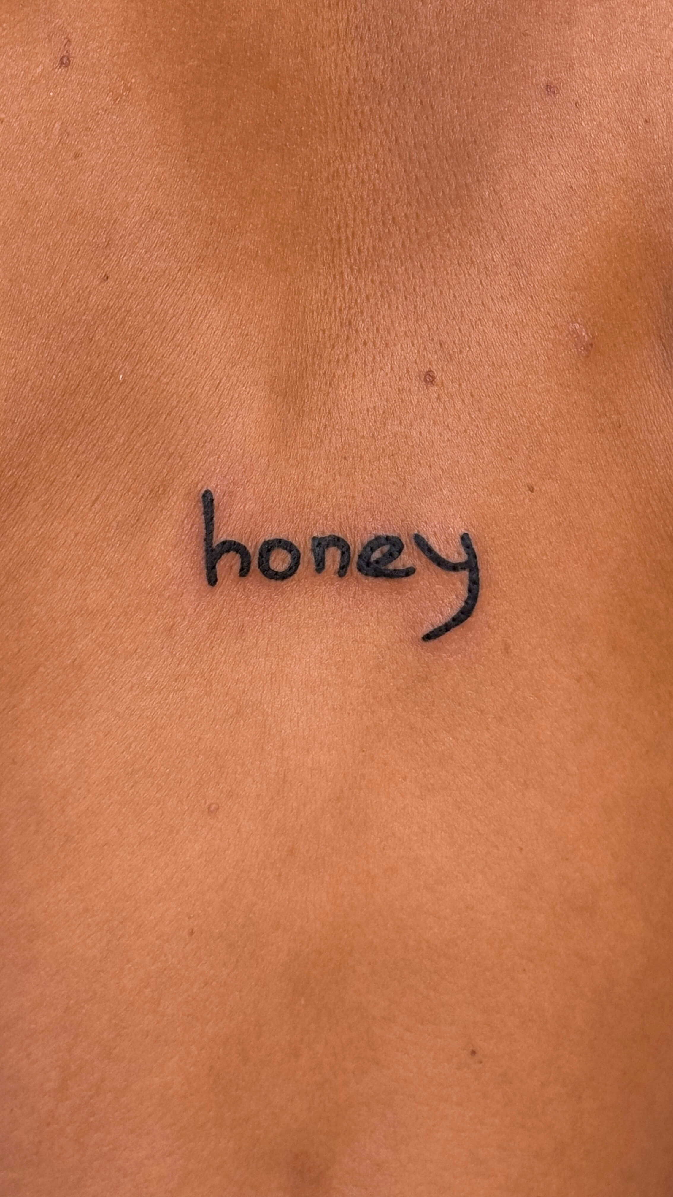 Fine line lettering tattoo, chest, script motif, Valencia
