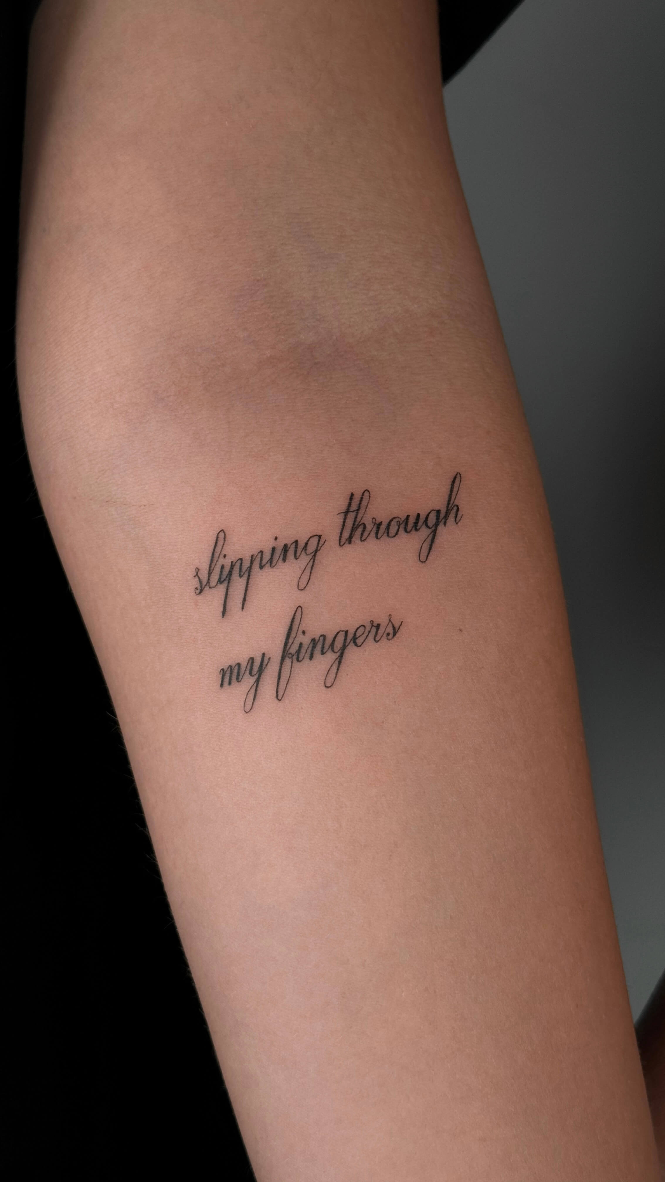 Fine line lettering tattoo on the arm