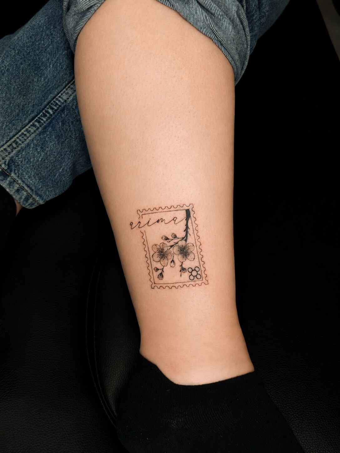 Fine line tattoo with a small linework symbol