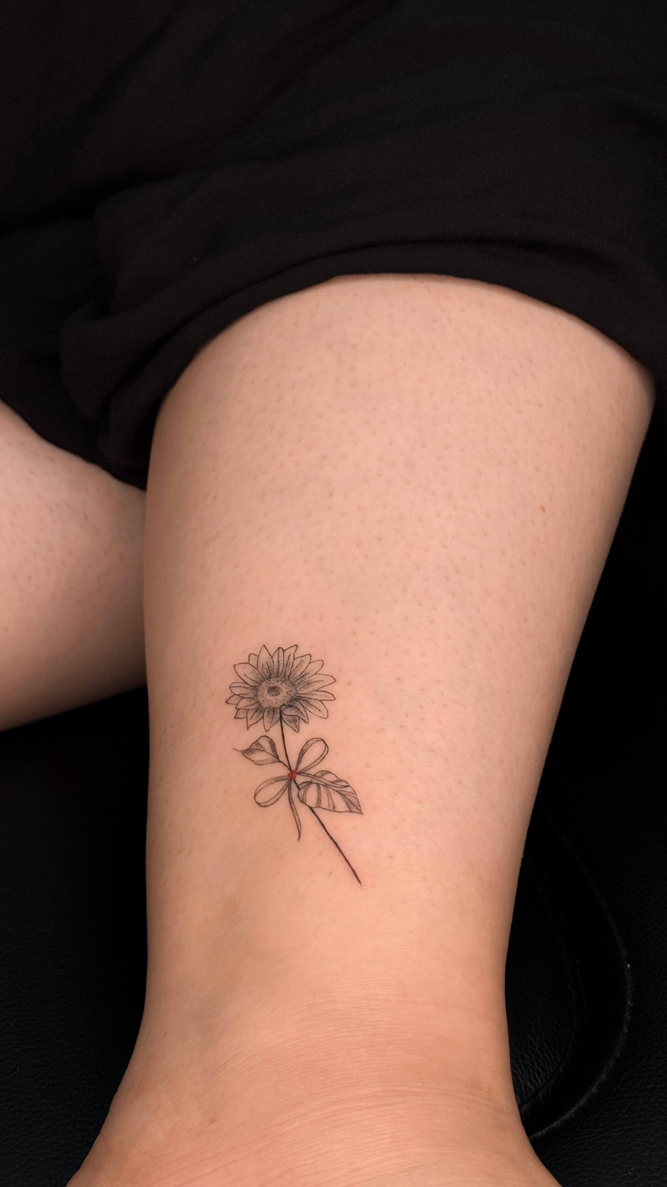 Fine line sunflower tattoo on the ankle
