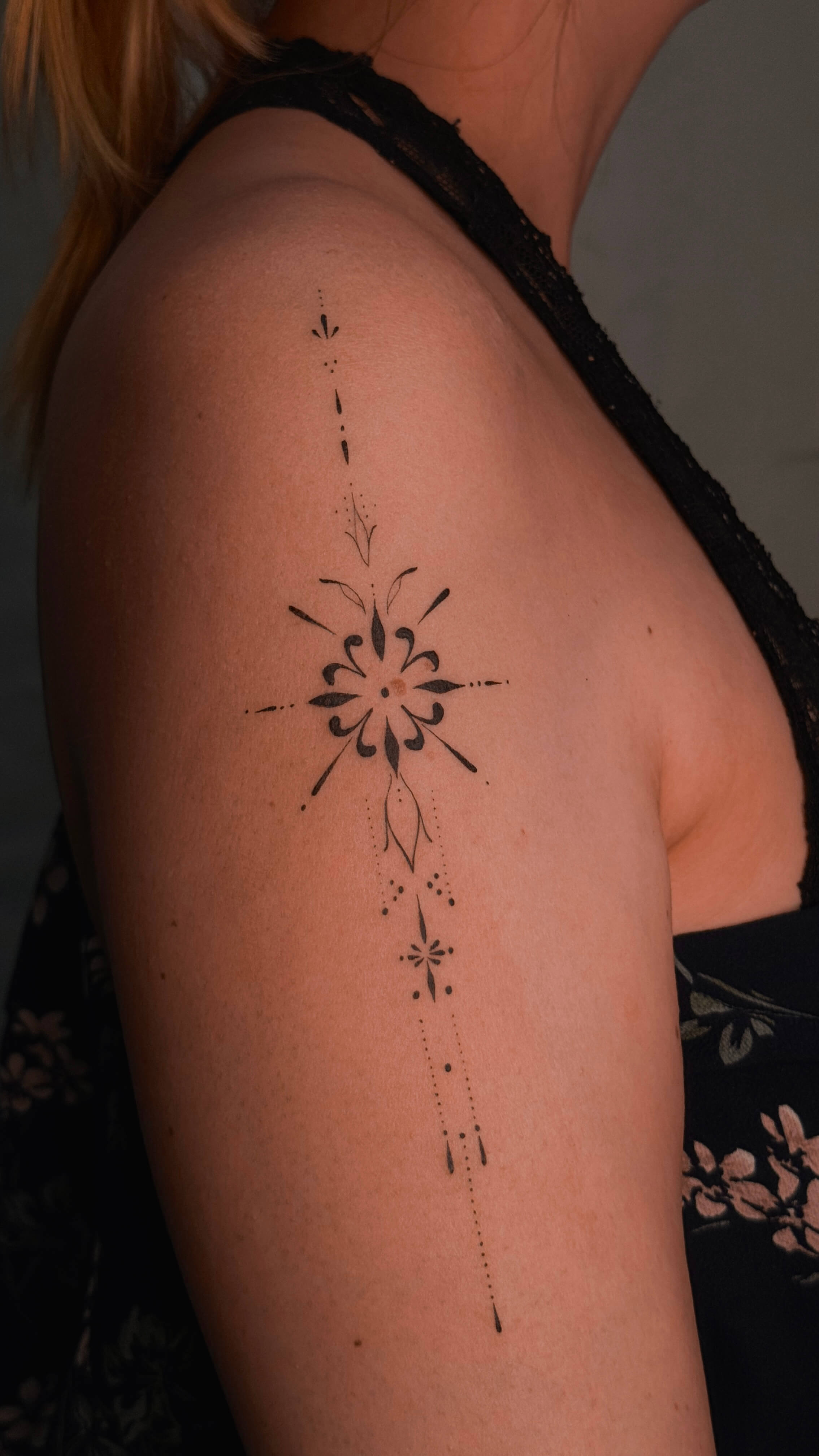 Ornamental fine line tattoo on the shoulder