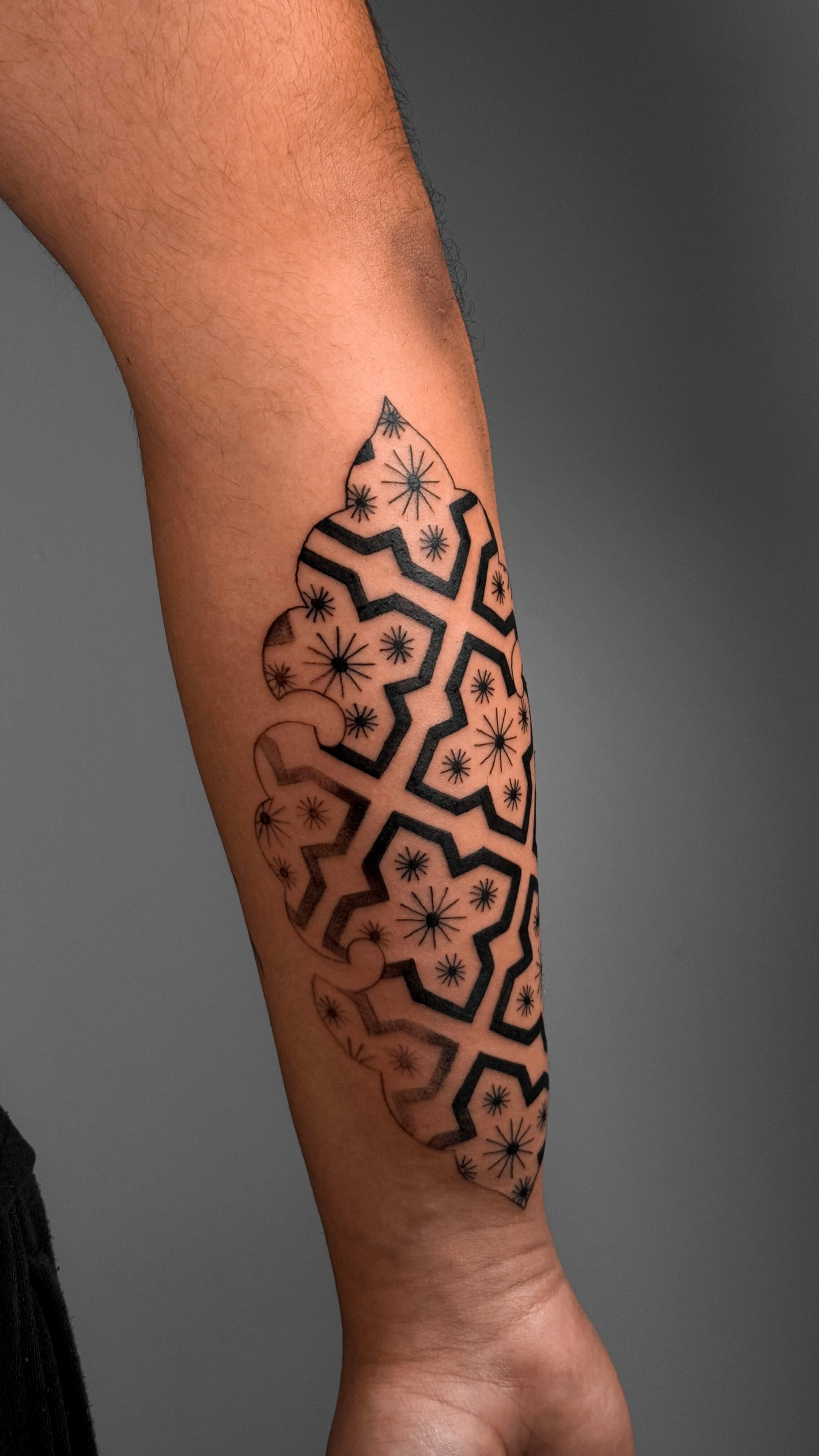 Ornamental blackwork tattoo on the forearm