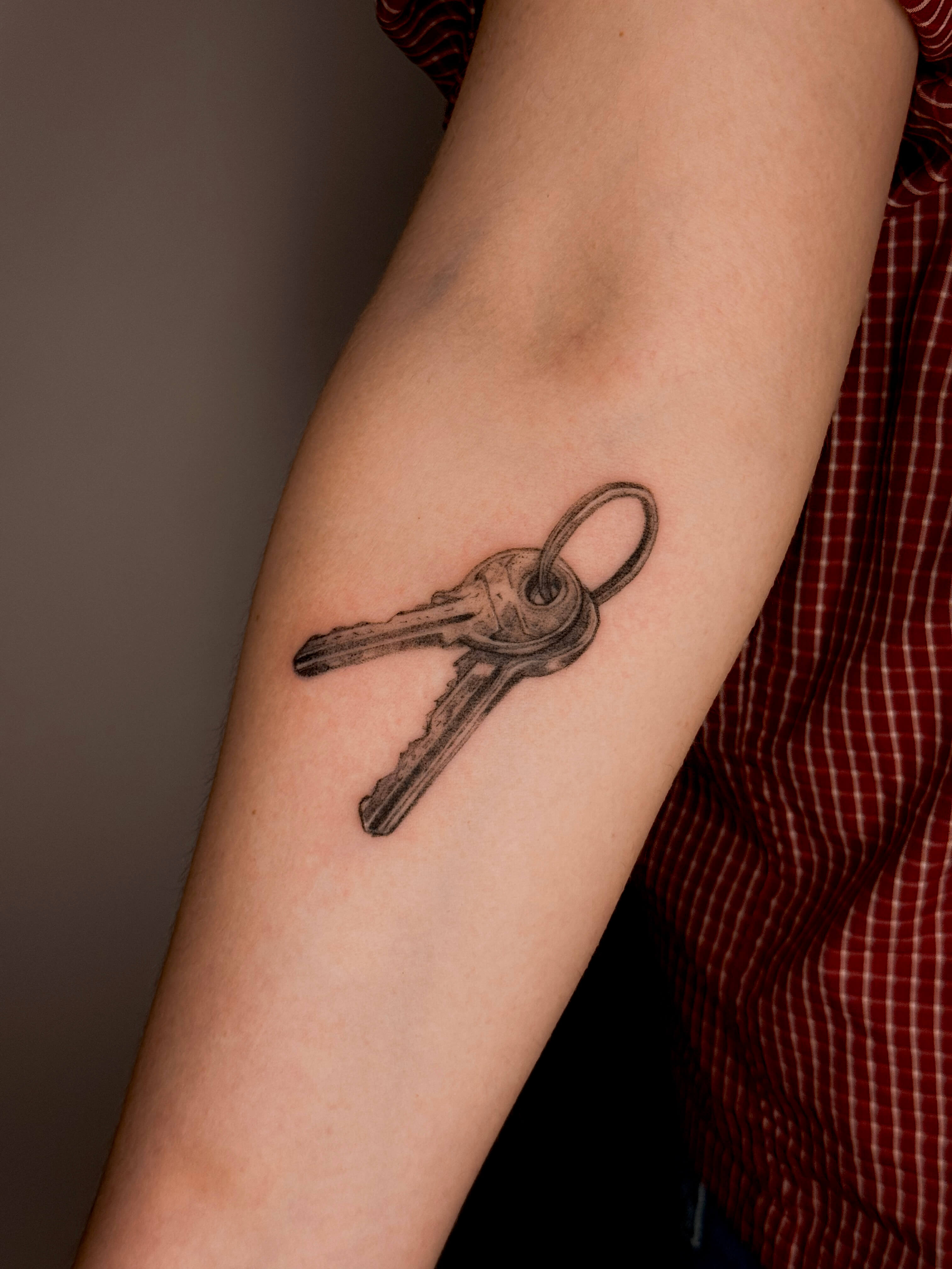 Micro-realism keys tattoo on the arm